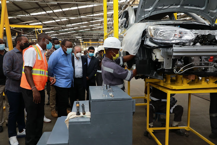 Governor Hassan Joho, Moses Aviero of Associated Vehicle Assemblers, President Uhuru Kenyatta, Simba Corp Group executive chairman Adil Popat, CEO Dinesh Kotecha and AVA Technician Reuben Mwaniki at AVA plant on Thursday.