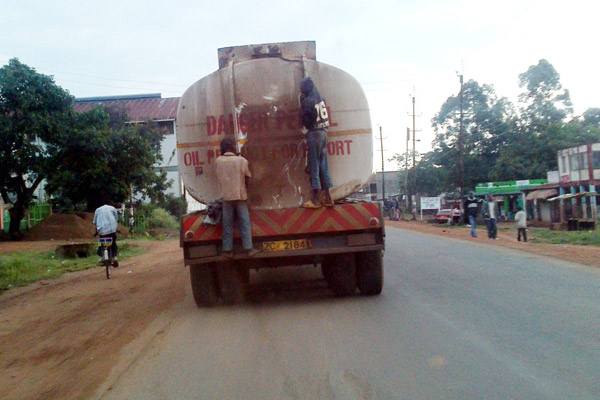 Street boys in Bungoma town get a free ride from this petroleum truck that was heading to Uganda without knowing the danger that they were facing in this picture taken on 4 August 2013
