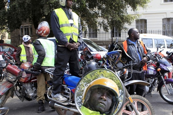 Kenyan motorcyclists park along a main street to protest over what they say is harassment by the City Council of Nairobi inspectors on traffic offences within the capital