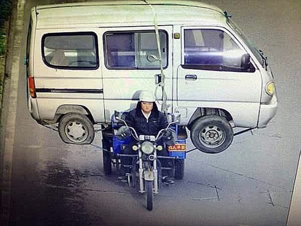 Man Carries Huge Minibus On Back Seat Of Three Wheeled Motorbike