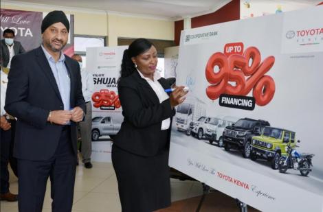 Co-op Bank Acting Director, Corporate and Institutional Banking Jackie Waithaka endorses the Toyota products display, witnessed by Toyota Kenya Managing Director Arvinder S. Reel at the launch of the joint financing deal that will offer up to 95% financing for the purchase of Toyota vehicles.