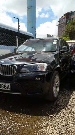 A very clean black BMW x3 with panoramic sunroof. full